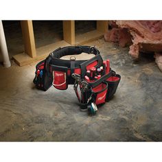 a tool belt with tools in it sitting on the ground