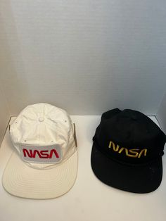 Buzz Aldrin NASA Triple Patch Snapback Hat / Cap Flat Bill Space Shuttle Caps! Includes both the black and the white Nasa hats shown.  Vintage sold as-is. All sales final. Flat Bill Trucker Hat With Patches, Navy Flat Bill Snapback Hat, Vintage Six-panel Snapback Hat For Sports, Vintage 5-panel Snapback Hat For Sports, Nasa Patch, Buzz Aldrin, Space Shuttle, Hat Cap, Snapback Hat