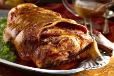 a large piece of meat sitting on top of a plate next to some parsley