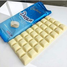 a white chocolate bar next to a blue and white candy bar