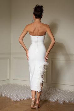 Try something daring and wild in our Leilani Stunning Feather White Dress! This showstopper features a strapless corset top and high-low flowing skirt with an eye-catching white feather embellished hem. Put it on and be the life of the party!   Model wearing size S  Model stats: Height-175cm/5'9" Bust-93cm/36.6" Waist-65cm/25.6 Hips-93cm/36.6"  Color may vary due to the lighting on images.  Item runs true to size chart and is cut to suit our size chart. Please refer to our size chart for the bes Strapless Dress With Feather Trim For Prom, Fitted Strapless Dress With Feathers, Fitted Feathered Strapless Dress For Night Out, Fitted Strapless Dress With Feather Trim For Night Out, Strapless Feather Trim Wedding Dress, Strapless Wedding Dress With Feather Trim, Cocktail Strapless Feather Trim Dress, Cocktail Strapless Sleeveless Dress With Feather Trim, Cocktail Strapless Dress With Feather Trim