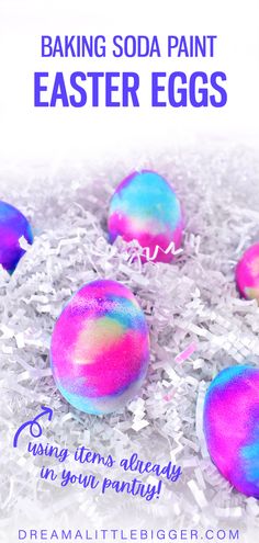 some colorful eggs sitting on top of white shredded paper with the words baking soda paint easter eggs