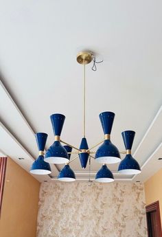 a blue chandelier hanging from the ceiling in a room