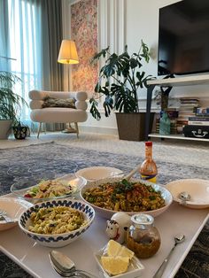 a tray filled with lots of food on top of a table next to a tv