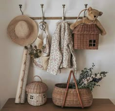 a shelf with baskets, hats and other items hanging on it's side wall