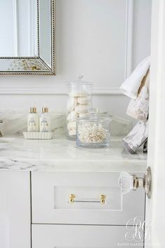 a bathroom vanity with soaps and other items on it