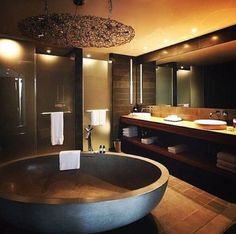 a large bath tub sitting in a bathroom next to a sink