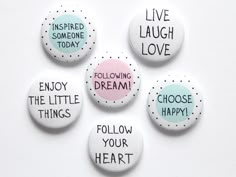 five buttons with different sayings on them