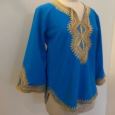 Beautiful Handmade In Morocco With Beautiful Hand Stitched Embroidered. Beautiful Bright Blue Color With Yellow Embroidered. Wear As Tunic Or Coverup Too. Excellent Condition / Never Worn Womens Size S 20 Pit-Pit 26 1/2 Length Acrylic Poly Knit Yellow Embroidered Blouse For Beach, Blue Tops With Machine Embroidery For Summer, Bohemian Blue Blouse With Geometric Embroidery, Blue Bohemian Blouse With Geometric Embroidery, Blue Embroidered Tunic Blouse, Traditional Blue Blouse For Vacation, Blue Tops With Embroidered Border For Spring, Traditional Blue Tops With Embroidered Border, Traditional Blue Blouse With Geometric Embroidery