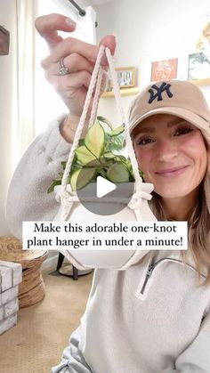 a woman holding up a plant in front of her face with the caption make this adorable one - knot plant hanger under a minute