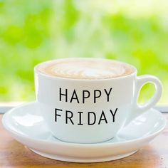 a white coffee cup with the words happy friday written on it sitting on a saucer