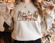 Gingerbread Christmas Coffee Sweatshirt Gift for Woman Christmas coffee Shirt Holiday Xmas Tee Coffee Lover Gift Santa Latte Drink Crewneck   Fall Sweater, Trendy Sweatshirt, Vintage Sweatshirt, Coffee Addict Sweatshirt Welcome to Style Art US! 𝐒𝐈𝐙E  𝗔ND 𝐂𝐎𝐋𝐎𝐑𝐒: For  size and color options,  please see listing images. Gildan Brand, 50% cotton, medium weight and soft. Usually runs true size.  DTF printing method is used for these shirts. 𝗛𝗢𝗪 𝗧𝗢 𝗢𝗥𝗗𝗘𝗥: 𝟏. Please, check and review listing photos. 𝟐. Select Your T-Shirt size and color from drop down menus. 𝟒. Choose Your Quantity you want. 𝟒. Click 𝗔𝗗𝗗 𝗧𝗢 𝗖𝗔𝗥𝗧. Go to your card and finalize your order. CARE INSTRUCTIONS: Turn the shirt inside out. Machine wash cold with mild detergent. Tumble dry very low. Do no Pickle Gifts, Christmas Pickle, Xmas Tees, Christmas Gingerbread House, Coffee Sweatshirt, Coffee Lover Gift, Gingerbread Christmas, Jingle Bell, Coffee Shirts