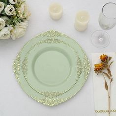 a place setting with flowers, candles and napkins