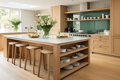 a large kitchen with wooden cabinets and white counter tops, along with bar stools