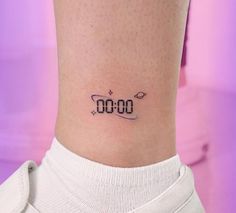 a woman's ankle with a clock tattoo on her left side ribcage