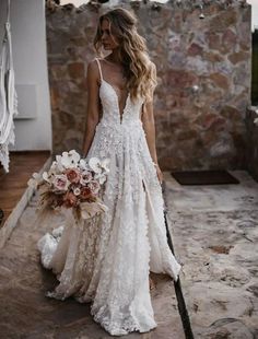 a woman in a wedding dress holding a bouquet