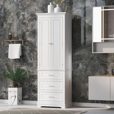 a bathroom with marble walls and flooring next to a white cabinet in the corner