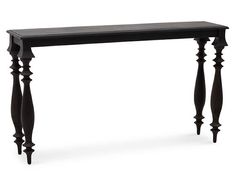 a black console table with wooden posts on the top and bottom, against a white background