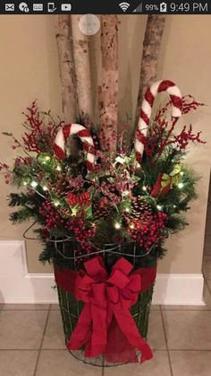 a basket filled with candy canes and christmas decorations