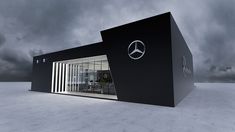 a black and white building with a mercedes logo on the front door is shown under a cloudy sky