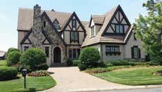 a large house with lots of windows and landscaping