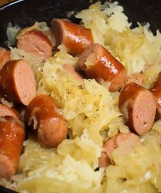 some sausages and sauerkraut in a black bowl