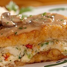 a close up of a plate of food with meat and gravy on it