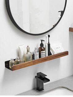 a bathroom sink with soap, toothbrushes and lotion on the shelf next to it