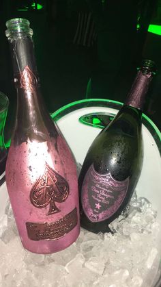 two bottles of champagne sitting on top of ice