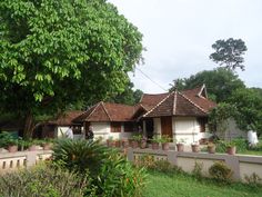 a couple of houses sitting next to each other on top of a lush green field