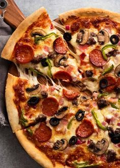 a pizza sitting on top of a pan covered in toppings