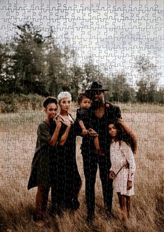 a group of people standing next to each other in a field