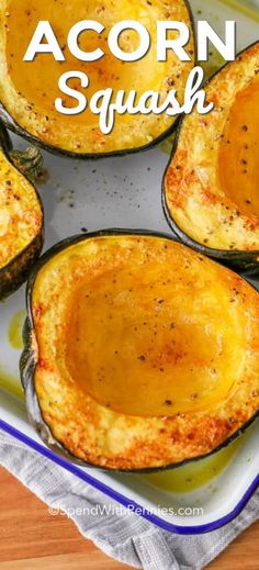 baked acorn squash in a casserole dish with the words acorn squash above it