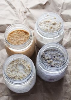 four jars filled with different types of food on top of a piece of wax paper