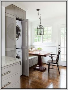 a washer and dryer sitting in a kitchen next to a dining room table