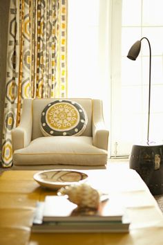 a living room filled with furniture and a lamp