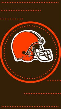 an orange and white football helmet on a brown background