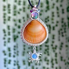 One of a kind, hand wire-wrapped pendant featuring an orange cockle shell (found off the fl shores), flashy abalone shell, mixed beads, & sun charm wrapped in plated silver. (Named after one of YOU.)💗 Free black necklace cord included; Made with love, as always.<3 Beach Wire Wrapped Shell, Handmade Spiritual Shell, Bohemian Wire Wrapped Shell As Gift, Bohemian Wire Wrapped Shell Gift, Ocean-inspired Wire Wrapped Shell, Handmade Shell Pendant In Ocean-inspired Style, Wire Wrapped Shell Gift, Bohemian Abalone Shell For Gift, Handmade Ocean-inspired Abalone Shell