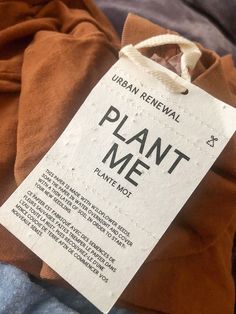 a plant me t - shirt with a label on it