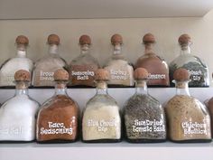 there are many bottles with different types of spices in them on the shelf next to each other