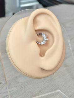 a close up of a fake ear with a ring on it