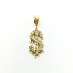 Subtly iced with diamonds, this gold dollar sign pendant appears to be dripping as if it were melting down due to the hot style this piece exudes. Precious Metal: 14 Karat Yellow Gold Gemstone: White Diamonds Cut: Round Brilliant Carat: Approx. 0.40* Height: 32.68 mm* Width: 11.40 mm* Approx. Weight: ~2.7 grams* *All weights and measurements are approximate. **Necklace sold separately. Please contact us if you have further questions about alternate sizes or styles, availability, specifications, Jewelry Website Design, Gold Dollar, Dollar Sign, Hot Style, Jewelry Website, Popular Jewelry, Hip Hop Jewelry, Precious Metal, White Diamonds