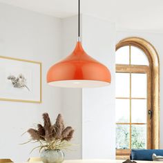 an orange light hanging over a dining room table