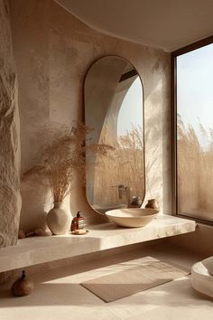 a bathroom with a large window, sink and mirror