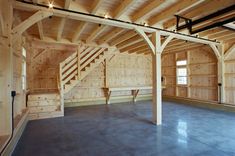 an empty room with wooden walls and stairs