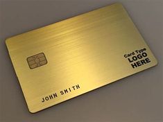 a gold metal credit card with the name john smith on it and black lettering that reads,'logo here '