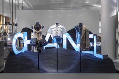 an open window display with mannequins and clothing