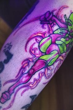 a close up of a person's arm with tattoos on it