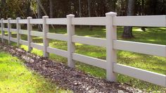 a white picket fence in the grass