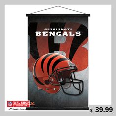 a football helmet hanging from the side of a sign that says cincinnati's bengalils